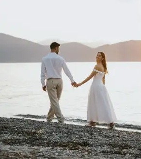 Couple walking along the shore